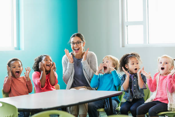 istock Multi-ethnic preschool teacher and students in classroom 1092433566