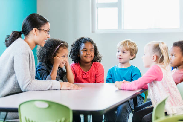 istock Multi-ethnic preschool teacher and students in classroom 1092433840