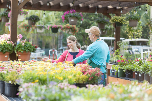istock Worker helping customer in plant nursery 1092437446