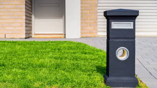 Brand new Australian house freestanding mailbox on green lawn at front yard