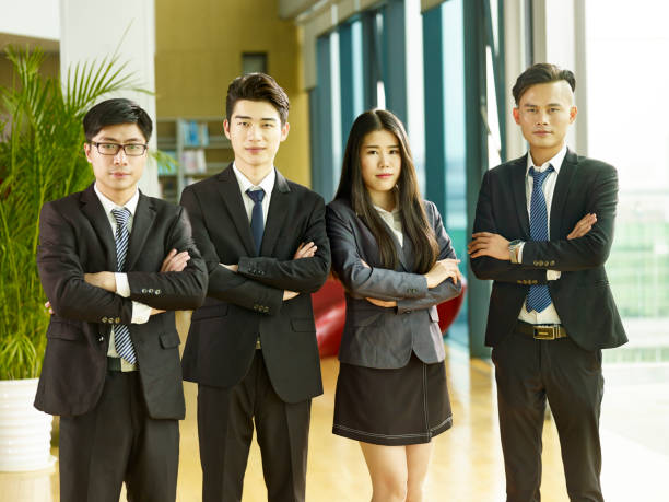 istock young asian employees standing in company lobby 1092463266
