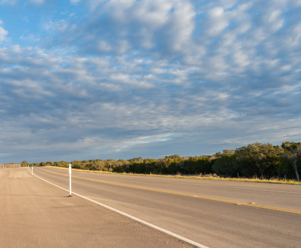 istock View of Single Lane Road with Cloudy Skies 1092463576