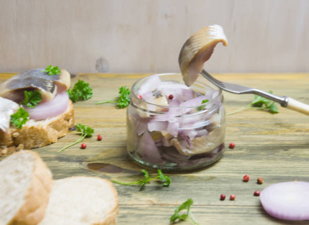istock sandwich with herring and onions, fork on wooden background selective focus 1092476184