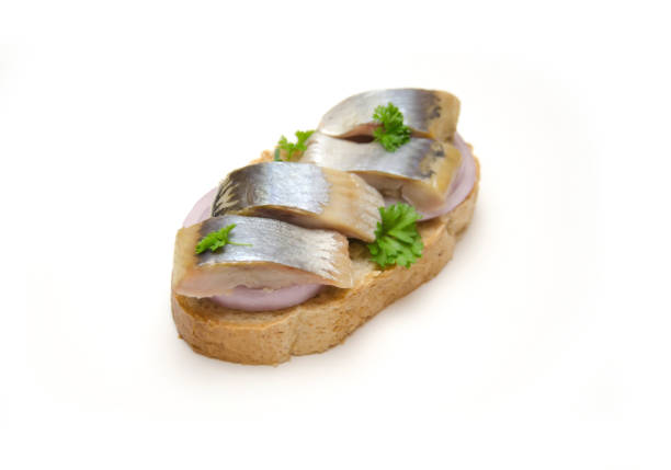 istock sandwich with herring and onion on white background 1092476478