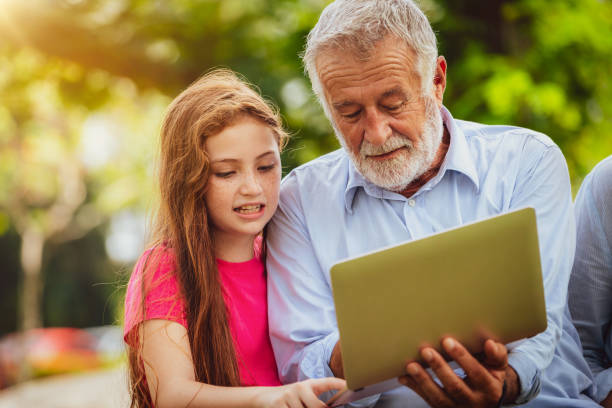 istock Happy family using laptop computer in public park. 1092490098