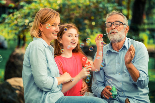 istock Happy family blowing soap bubbles in the park. 1092490242