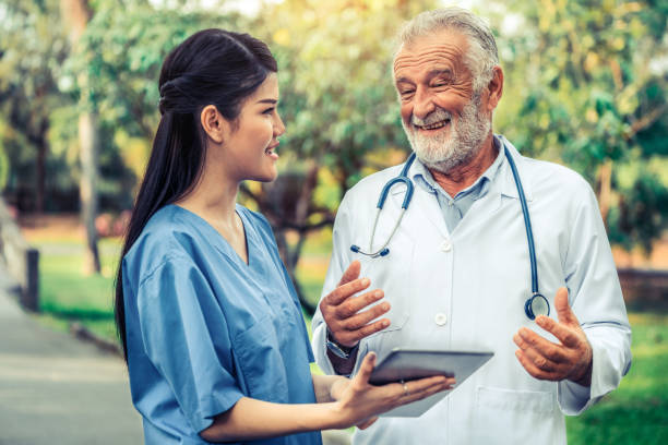 istock Senior and young doctor working in the park. 1092490352