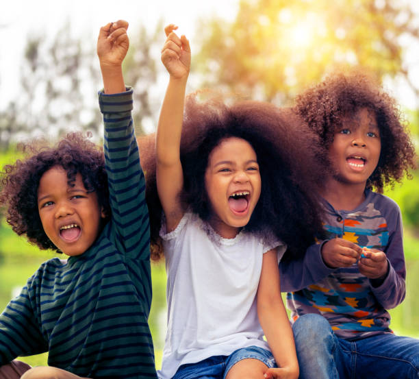 istock Happy kids group playing in the park in school. 1092492156