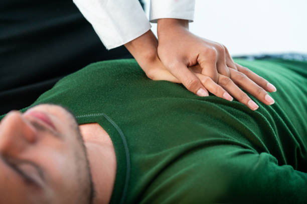 istock Rescuer hands doing CPR on heart attacked man. 1092507724