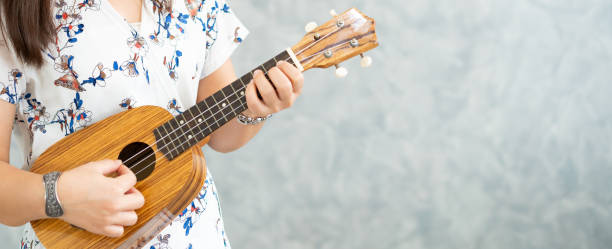 istock Happy woman musician playing ukulele in studio. 1092507866