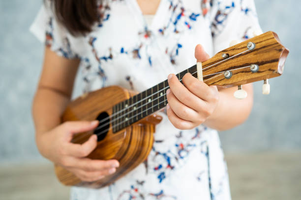 istock Happy woman musician playing ukulele in studio. 1092507874