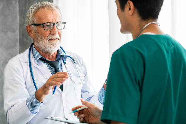 istock Senior male doctor working with another doctor. 1092508056
