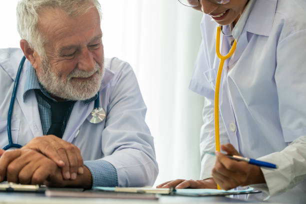 istock Senior male doctor working with another doctor. 1092508372