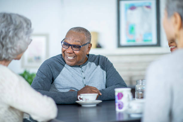 istock Senior man laughing with friends 1092510552