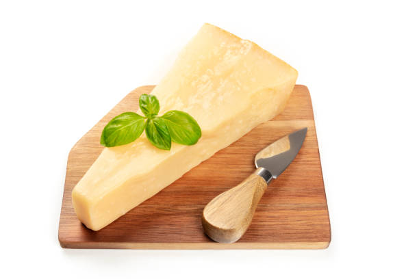 istock A cutting board with aged Parmesan cheese with fresh basil leaves and a cheese knife on a white background with copy space 1092514334