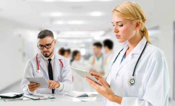 istock Doctor at hospital works on computer with partner. 1092518582