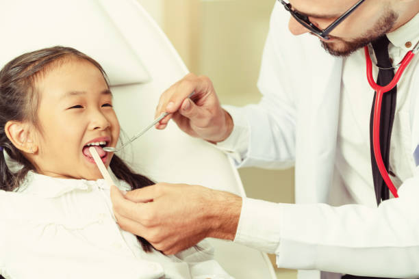 istock Dentist examining child teeth in dental clinic. 1092521756