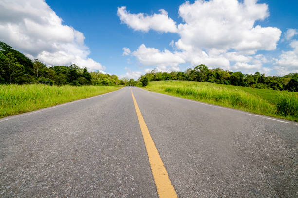 istock Highway road through green grass under blue sky. 1092522064