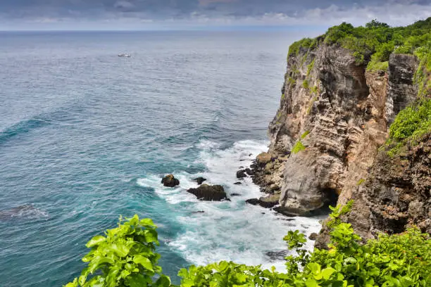 Photo of View of Uluwatu cliff with pavilion and blue sea in Bali, Indonesia