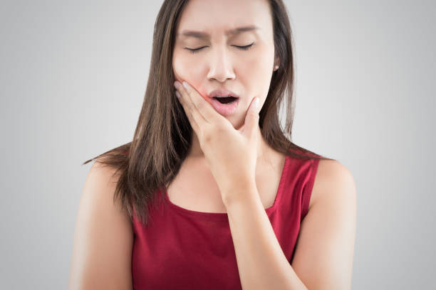 Woman suffering from a toothache.