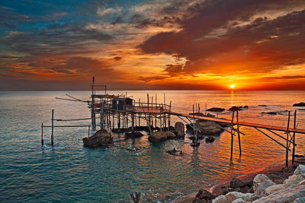 Rocca San Giovanni, Chieti, Abruzzo, Italy: Adriatic sea coast with a fishing hut trabocco Rocca San Giovanni, Chieti, Abruzzo, Italy: Adriatic sea coast at dawn with an ancient fishing hut trabocco, the typical mediterranean wooden pilework chieti stock pictures, royalty-free photos & images