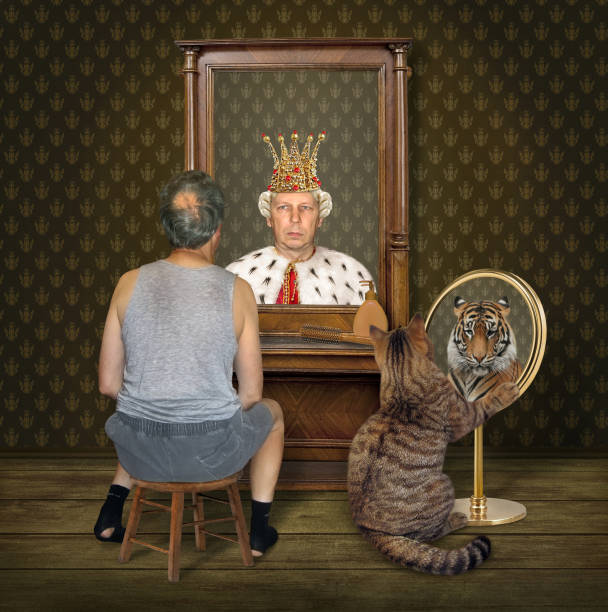 istock Cat and man look at their reflections 2 1092562722