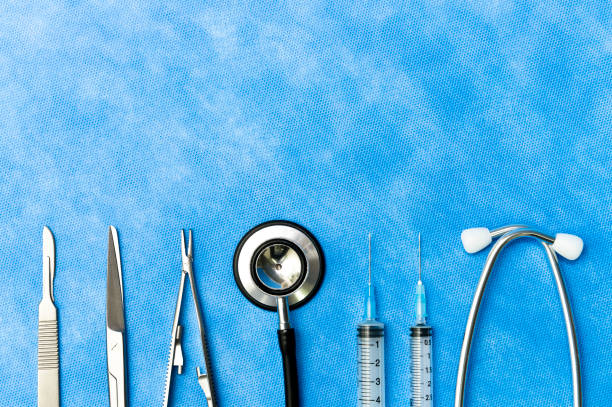 Medical surgical instruments and blue sterilization wraps for surgeon in hospital stock photo