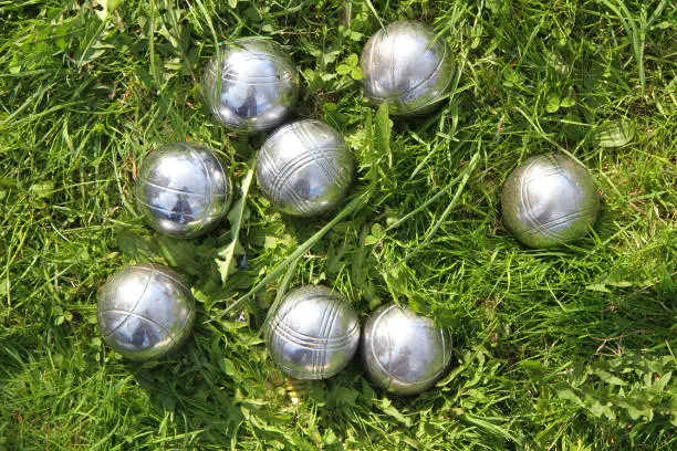 Photo of petanque bowls in the green grass