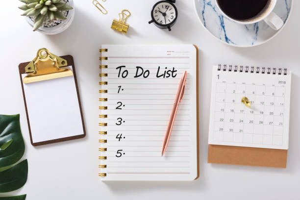 To do list in notebook with calendar To do list in notebook with calendar and clock on white desk to do list stock pictures, royalty-free photos & images