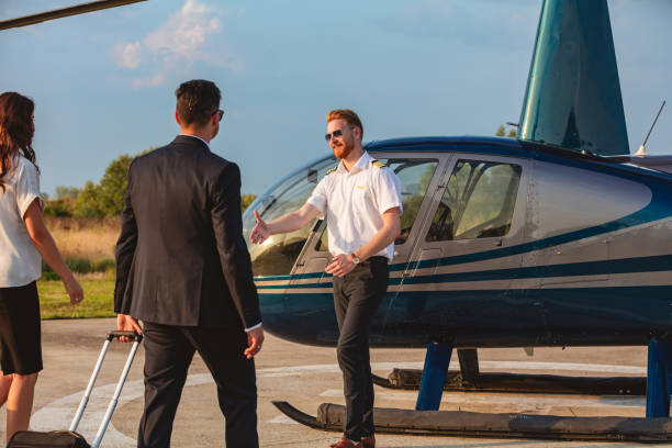 istock Cheerful helicopter pilot reaching for handshake 1092572212