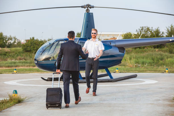 istock Helicopter pilot and passenger reaching for handshake 1092572216