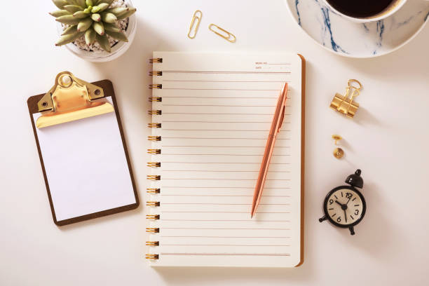 istock Flat lay desk with notebook and golden accessories 1092572366