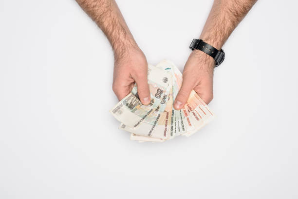 istock cropped view of man counting Russian rubles isolated on grey 1092572446
