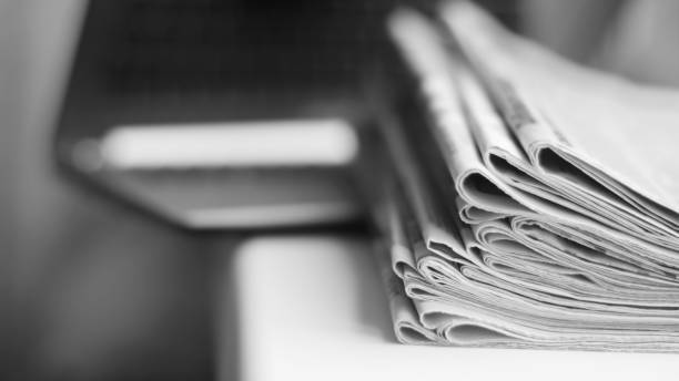 istock Newspapers and laptop 1092580860
