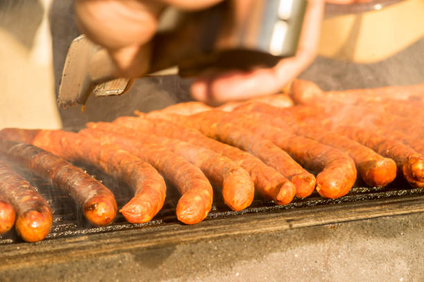istock Grilled sausages on grill with smoke 1092580944