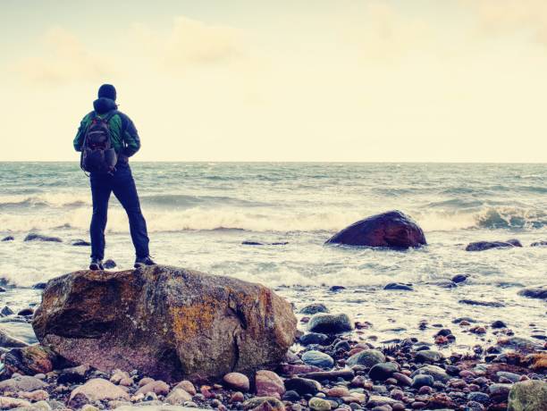 istock Young man with touristic suit looking on amazing seascape 1092581602
