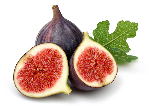 Fresh purple fig fruit and slices with leaf isolated on white background