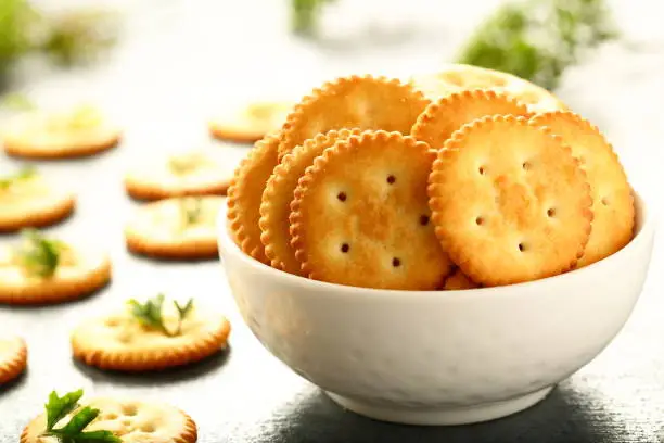 Delicious salted biscuits crackers in white bowl