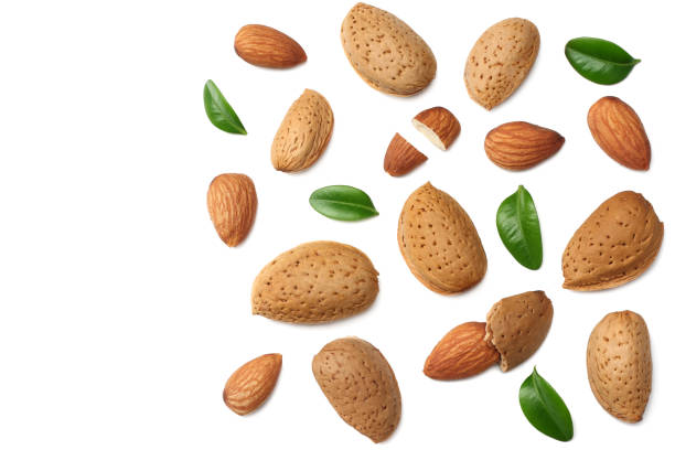 istock almonds with green leaves isolated on white background. top view. 1092585884