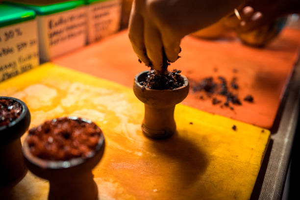 istock A man prepare hookah sisha in hookah art bar. Tabaco preparation. 1092604730