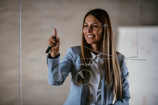 istock Woman drawing chart on glass wall 1092604800