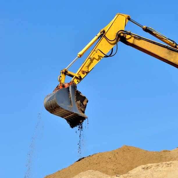 istock new yellow excavator working on sand dunes. Scoop close-up 1092607080