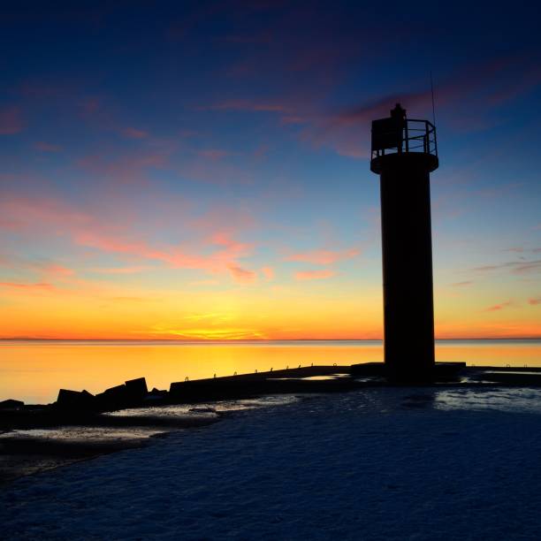 istock lighthouse in the sea at the colorful sunset 1092610700