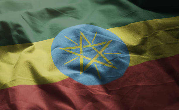 Hand with two finger up gesture in colored ethiopia national flag as symbol of winning, victorious, excellent, - for tourism and touristic advertising, positive political, cultural, social management of country