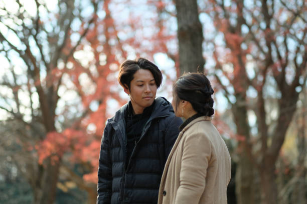 istock Couple talking and walking in Autumn park 1092620290