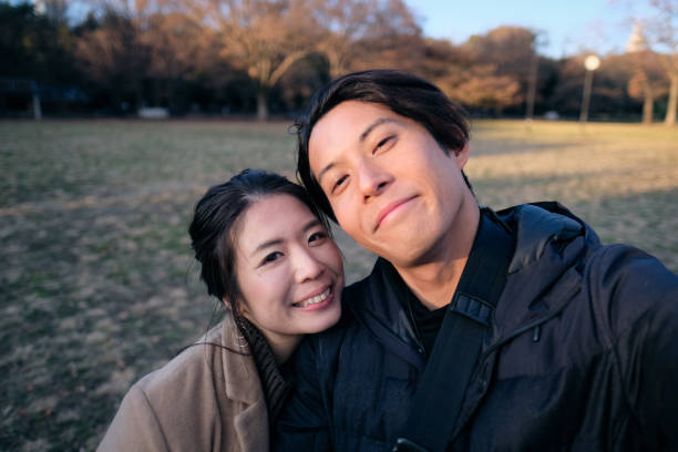 Couple taking selfie in park
