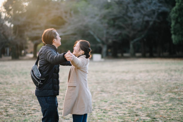 istock Couple holding hands in park 1092622448