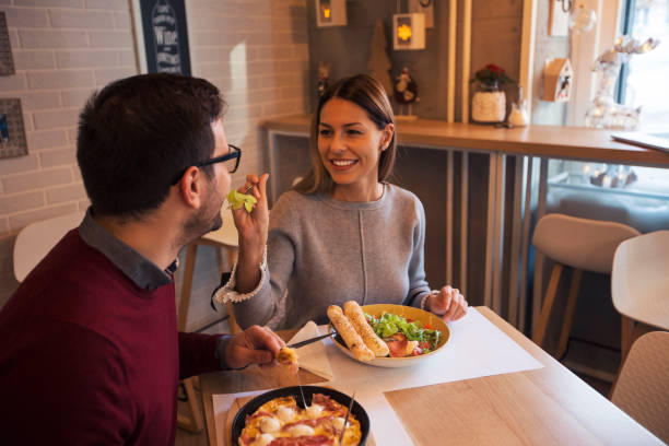 istock Woman feeding man at restaurant 1092623748