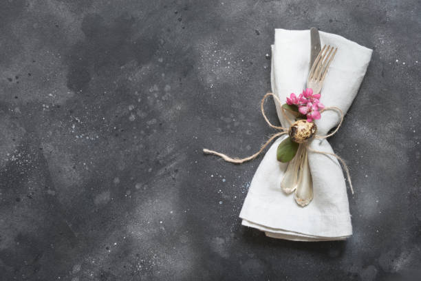 istock Easter dinner. Elegance table setting pink flowers on dark. Top view. 1092623750
