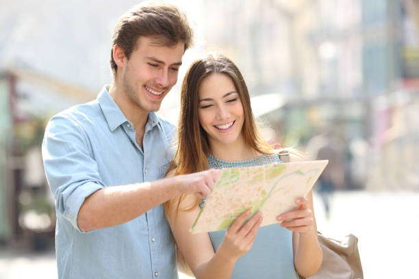 istock Happy couple checking paper map on vacation 1092626232
